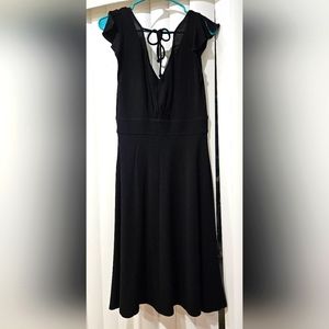 Bebe little black dress with slight plunge back and ties. Size medium.
